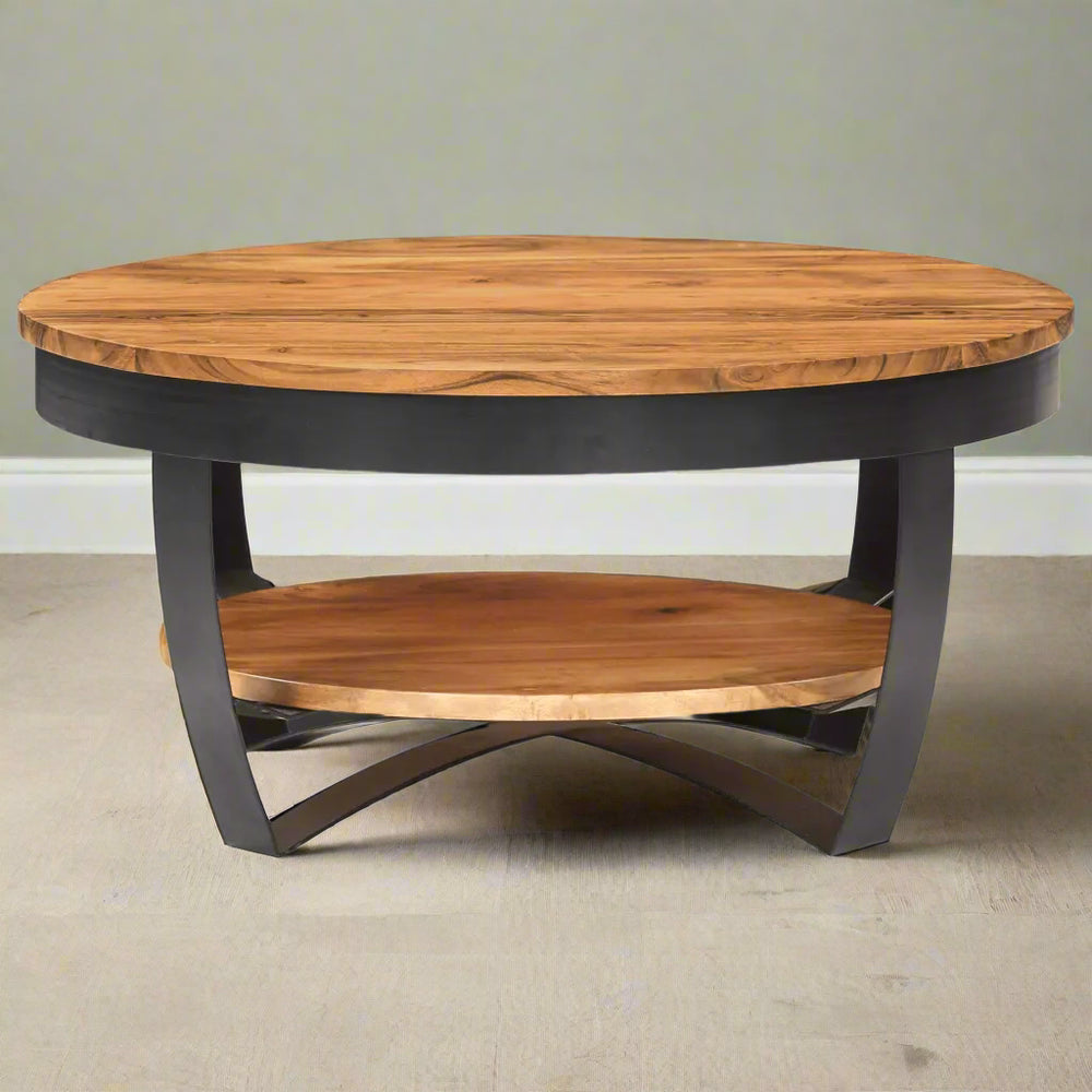 A coffee table with a honey oak finish on the tabletop and a black iron frame and lower shelf.
